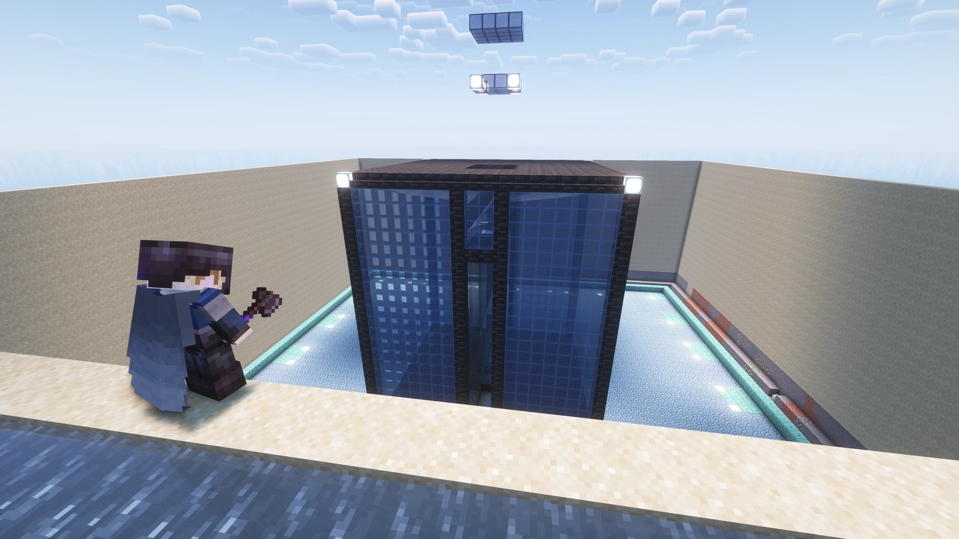 Me standing on top of one of the sand walls, looking inwards to the now completed Guardian farm. It's comprimised of two glass tanks full of water that funnel guardians into a central chamber where they fall and have their drops collected underground