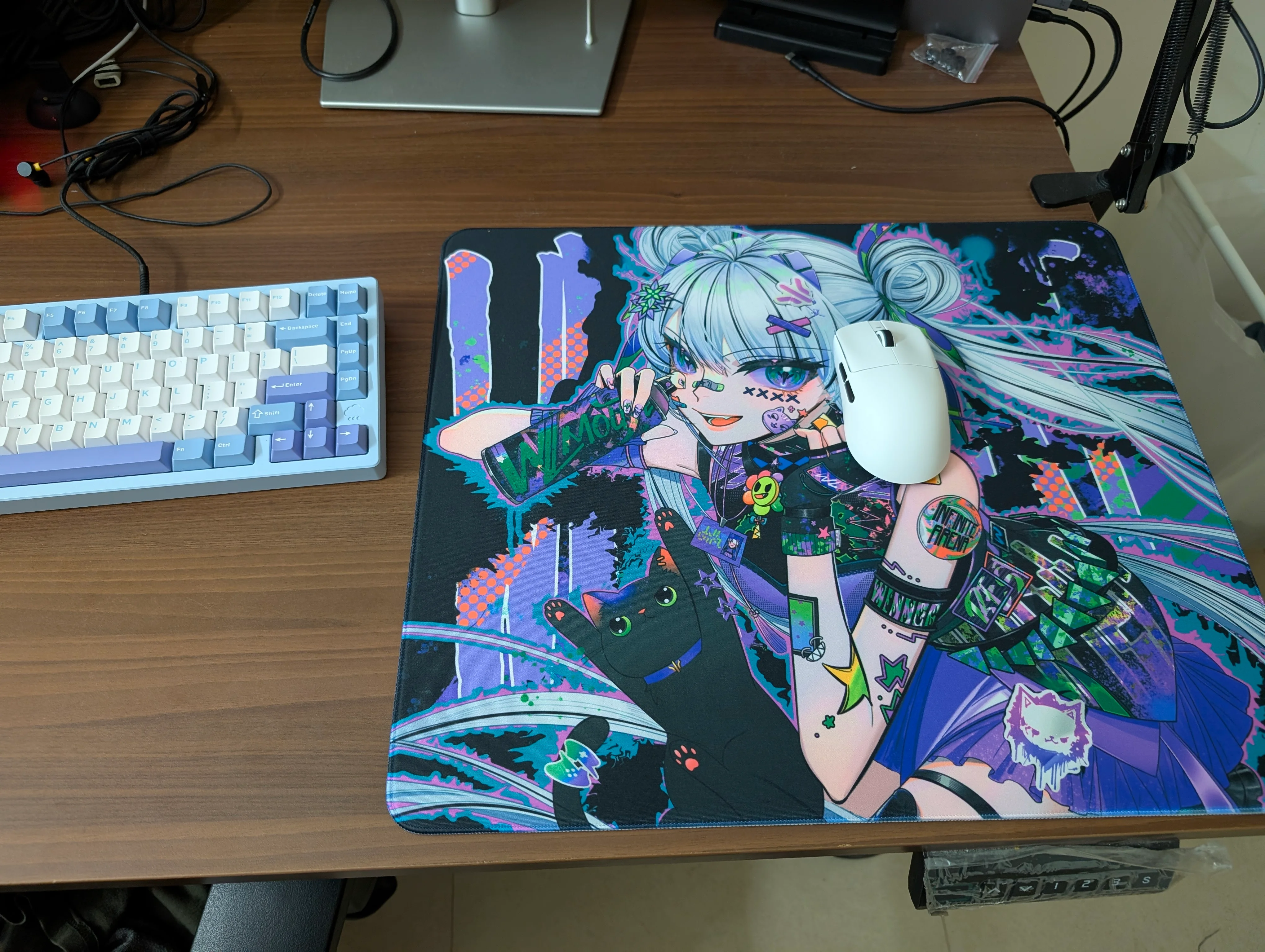 A cyberpunk style image of a girl with white hair and a can of paint in her hand. She has a lot of temporary tattoos all over her visible arm and a cute black cat reaching for the paint can. My mouse is resting next to her face.